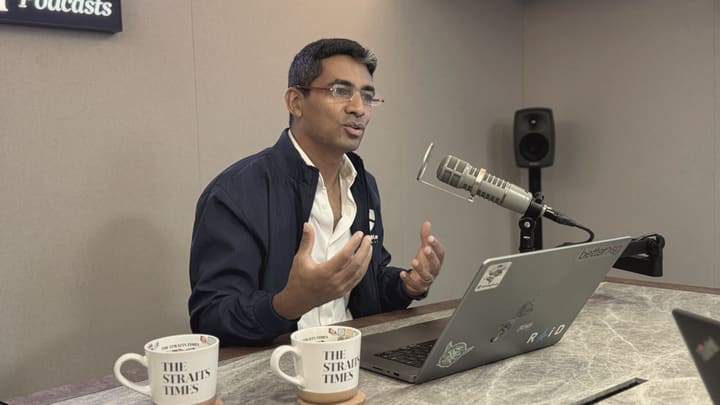 Gaurav at a podcast microphone, mid-sentence.